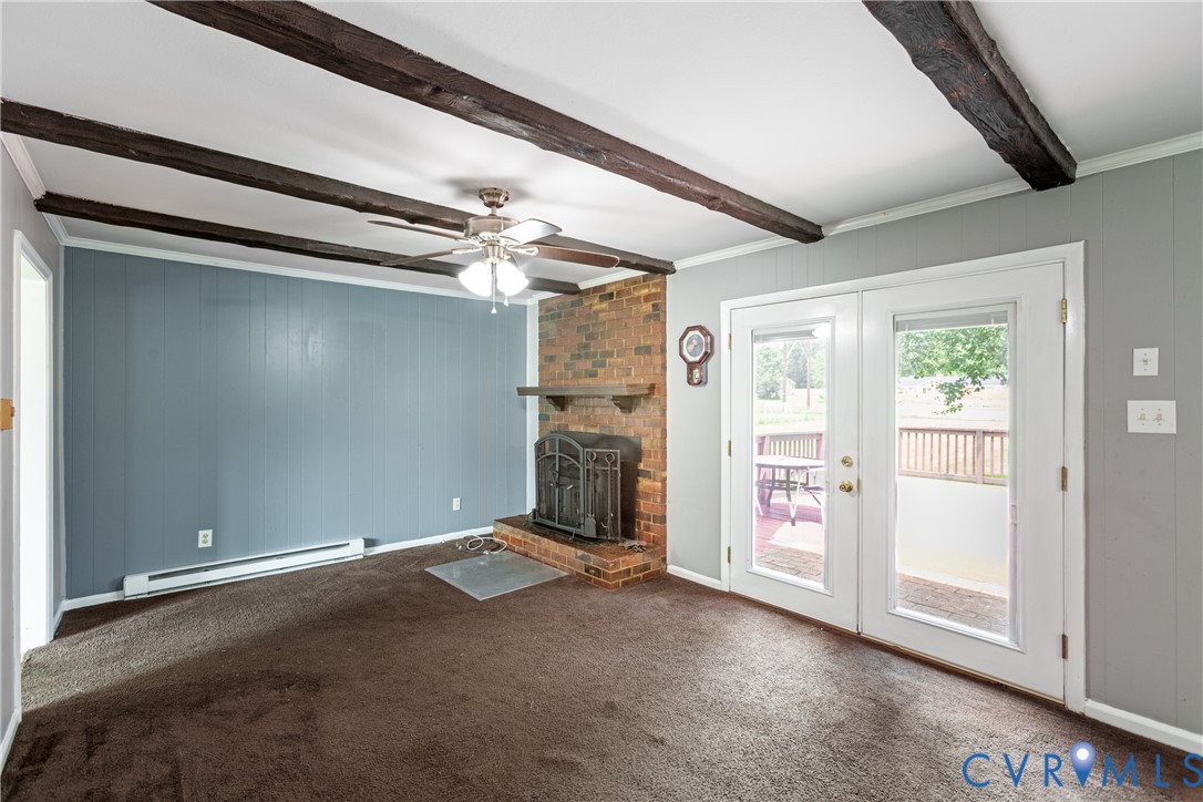 2730 Kinvan Road Henrico, VA 23231 - Photo 24 of 37 Exposed ceiling beams, brick fireplace with a meta