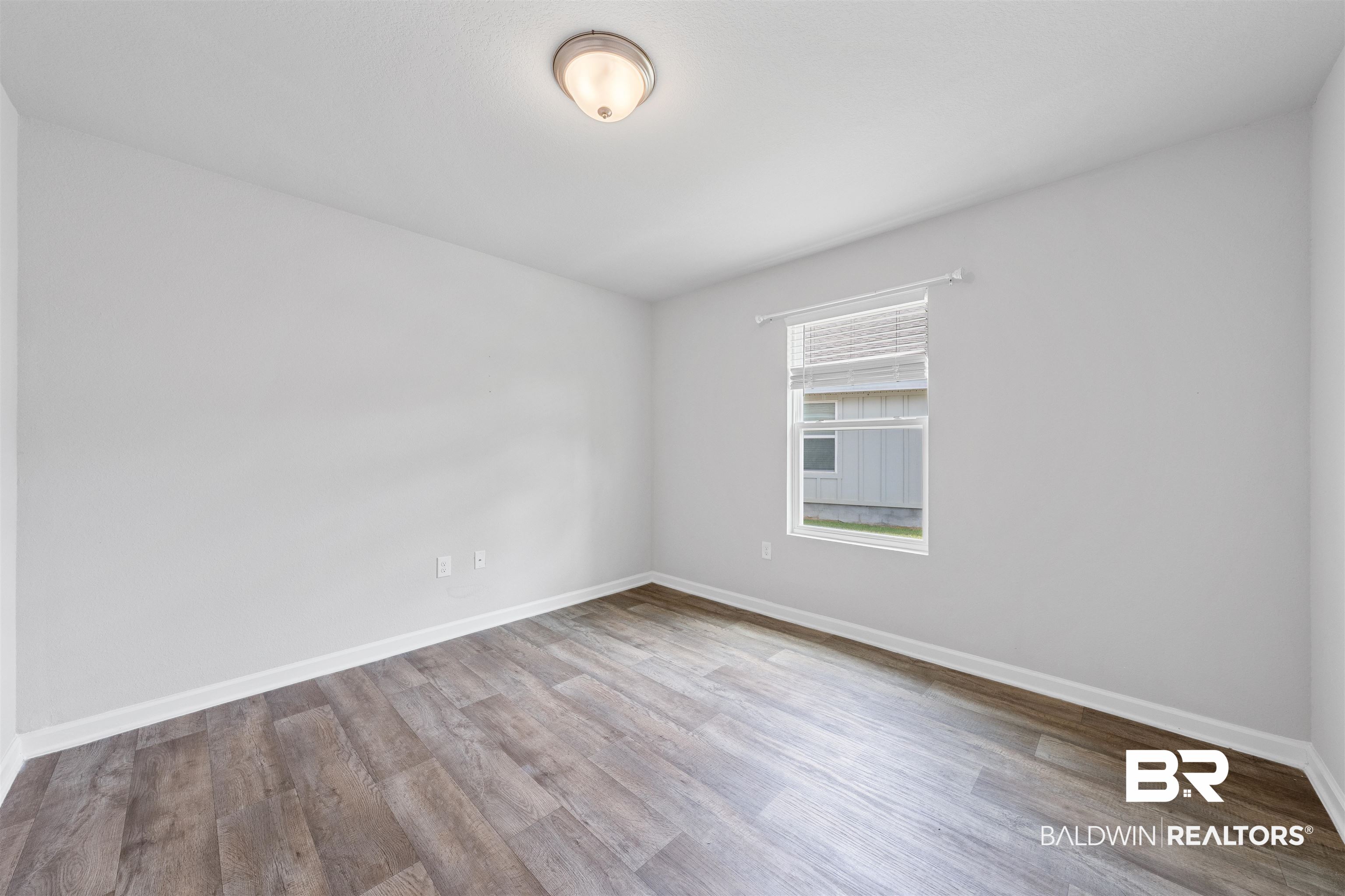 7457 Brompton Drive Foley, AL 36535 - Photo 21 of 24 Empty room featuring light wood finished floors and baseboards