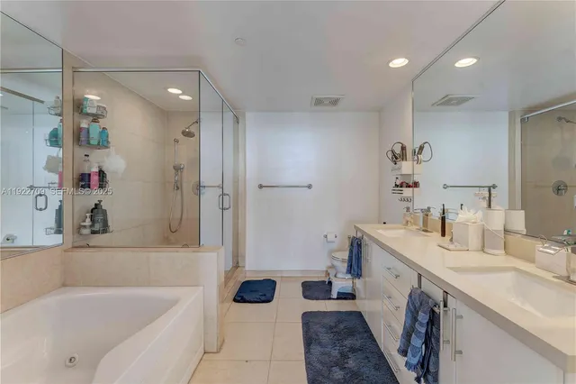 a bathroom with a tub sink and mirror