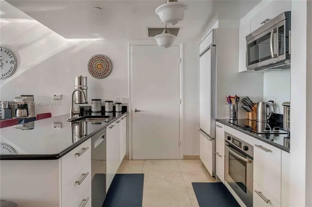 a kitchen with a sink dishwasher stove and refrigerator