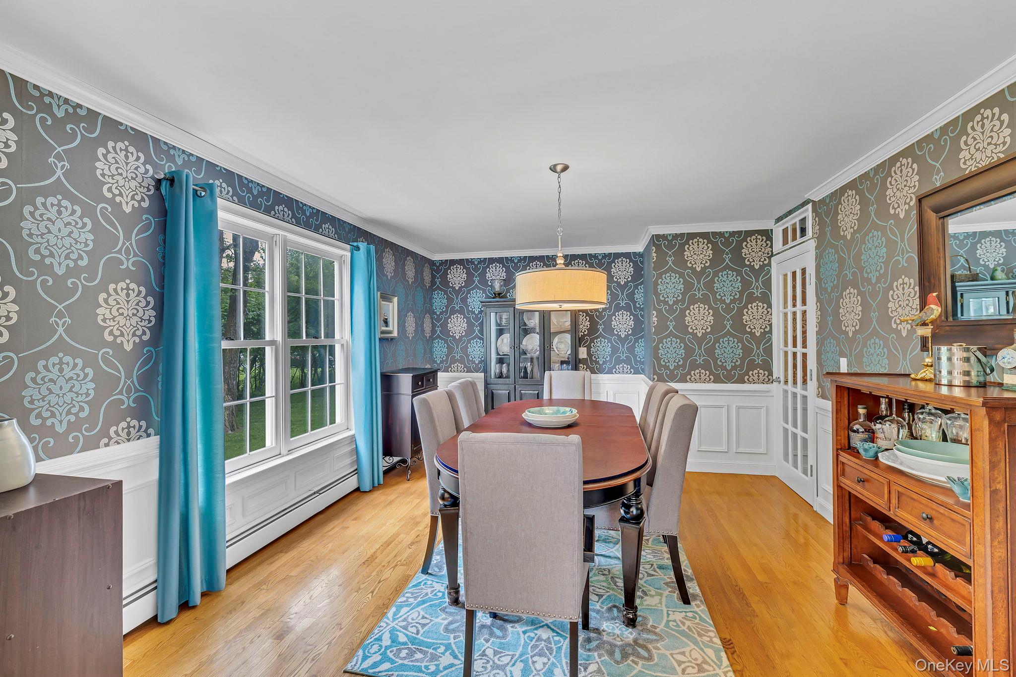 74 Vincent Lane Stone Ridge, NY 12484 - Photo 12 of 49 a dining room with furniture a flat screen tv and a floor to ceiling window