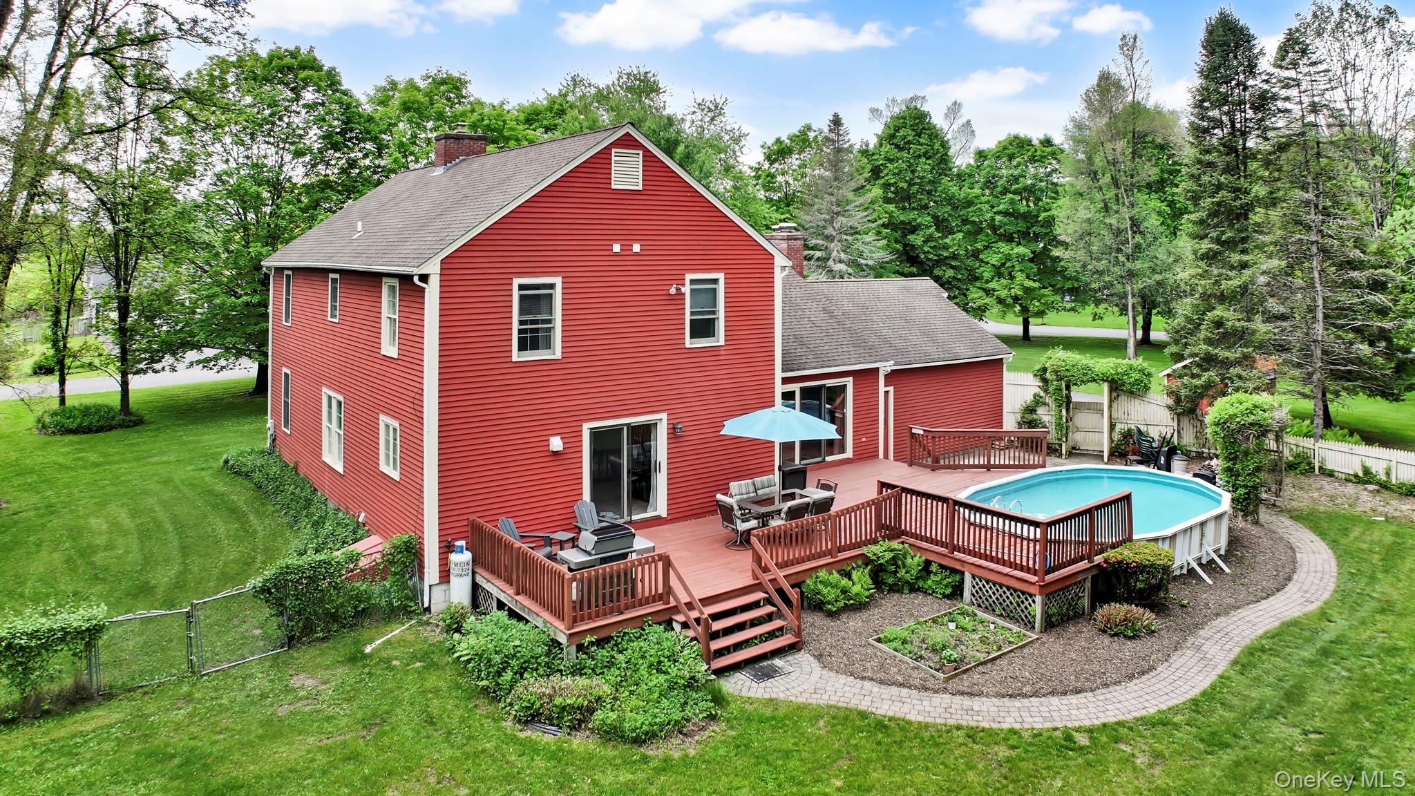 74 Vincent Lane Stone Ridge, NY 12484 - Photo 2 of 49 a aerial view of a house with table and chairs