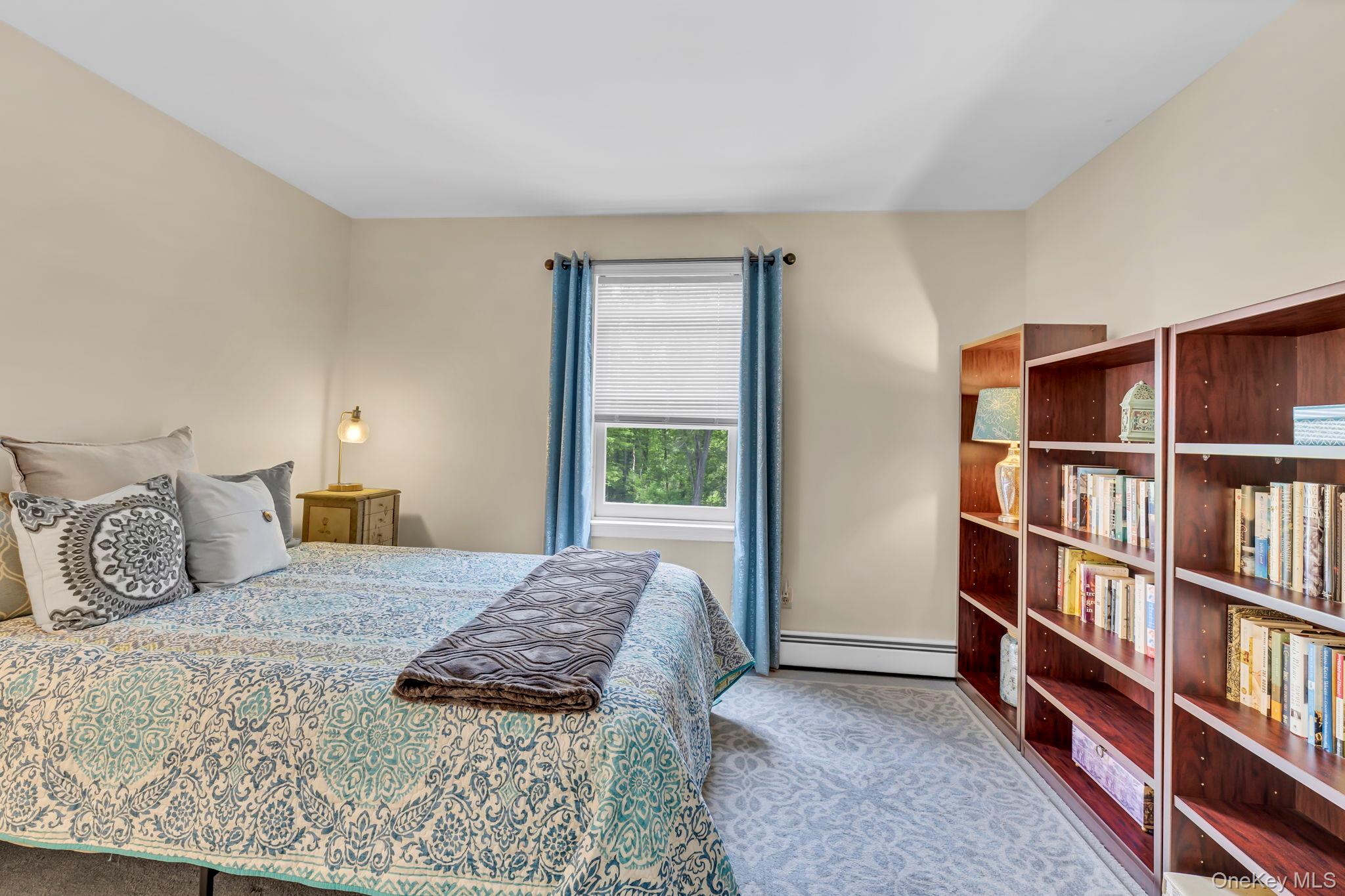 74 Vincent Lane Stone Ridge, NY 12484 - Photo 29 of 49 a bedroom with a bed and a book shelf