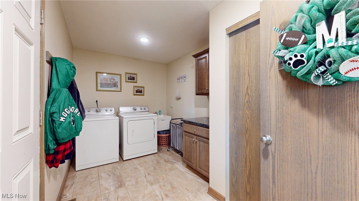 961 Industry Road Atwater, OH 44201 - Photo 32 of 50 Laundry area with washing machine and dryer, cabinet space, recessed lighting, and light tile patterned floors