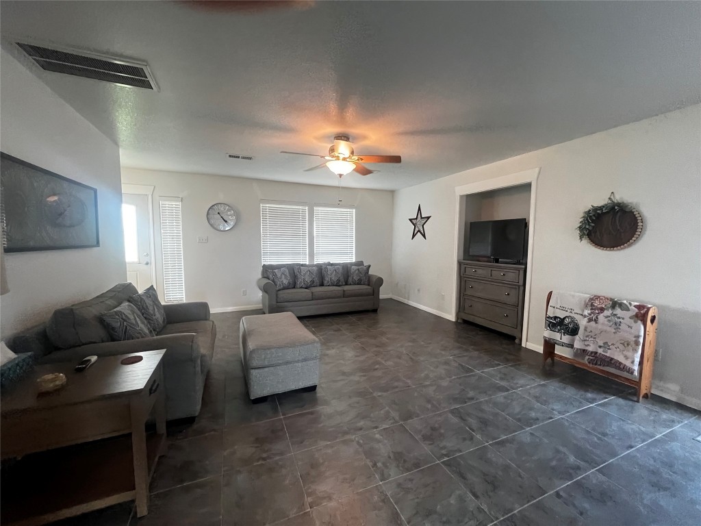 1100 Swiss Alp Hills Loop Schulenburg, TX 78956 - Photo 12 of 40 a living room with furniture and a flat screen tv