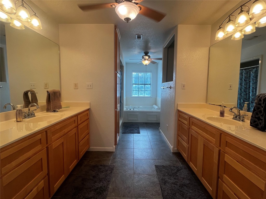 1100 Swiss Alp Hills Loop Schulenburg, TX 78956 - Photo 20 of 40 a bathroom with a double vanity sink and a mirror