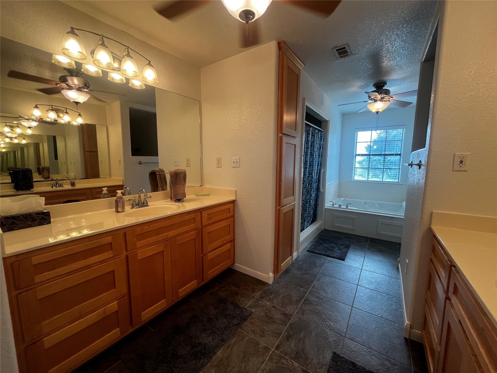 1100 Swiss Alp Hills Loop Schulenburg, TX 78956 - Photo 21 of 40 a bathroom with a double vanity sink and a mirror