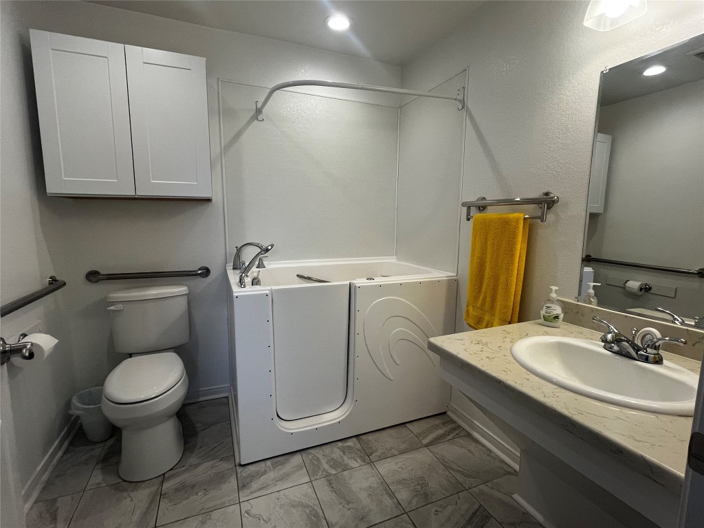 1100 Swiss Alp Hills Loop Schulenburg, TX 78956 - Photo 28 of 40 a bathroom with a toilet sink and mirror