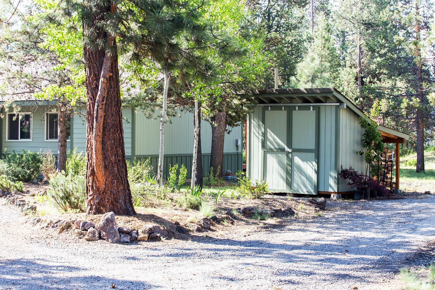 17325 Covina Road Bend, OR 97707 - Photo 21 of 25 Storage shed with wood behind stacked wi