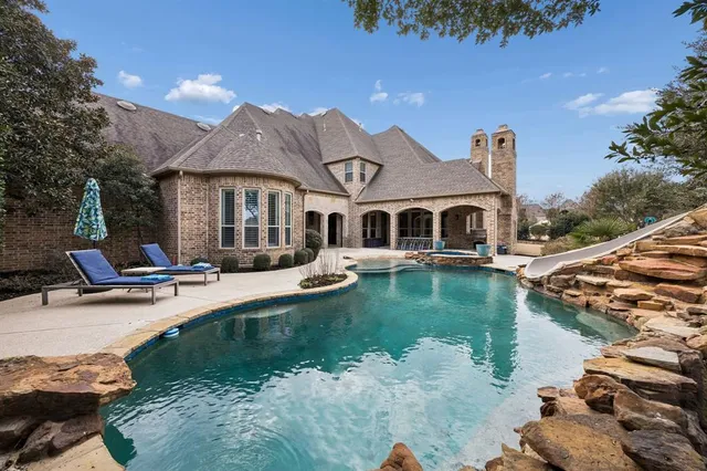a view of a house with pool and lake view