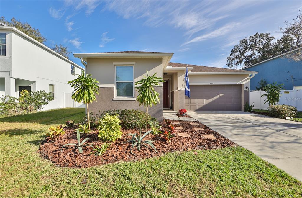 a front view of a house with garden