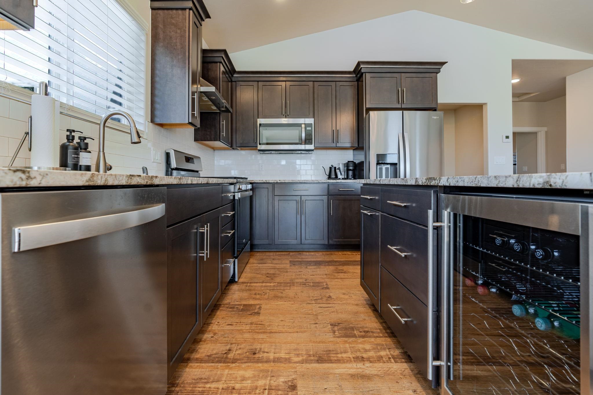 1301 M Road Loma, CO 81524 - Photo 18 of 32 a kitchen with kitchen island granite countertop a sink stainless steel appliances and cabinets