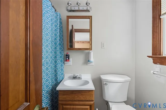 a bathroom with a sink toilet and mirror