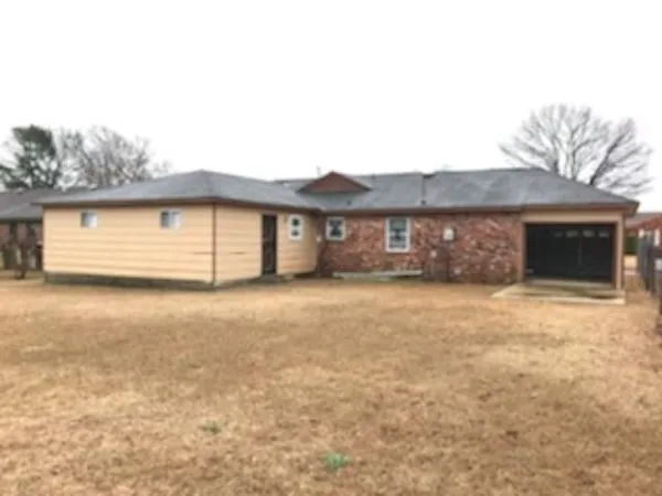 a front view of a house with a garden and garage