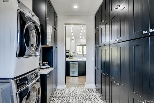 a kitchen with stainless steel appliances granite countertop a refrigerator a stove and a sink with wooden floor