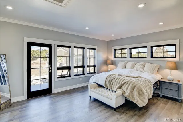 a spacious bedroom with a large bed and a large window