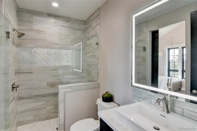 a bathroom with a sink toilet and shower