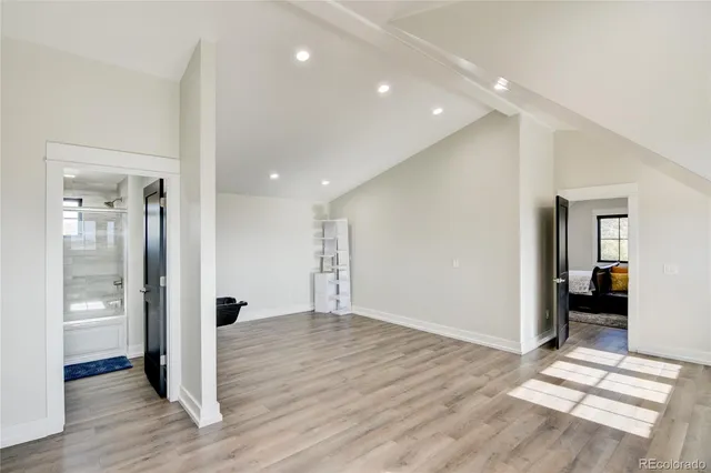 a view of hallway with wooden floor