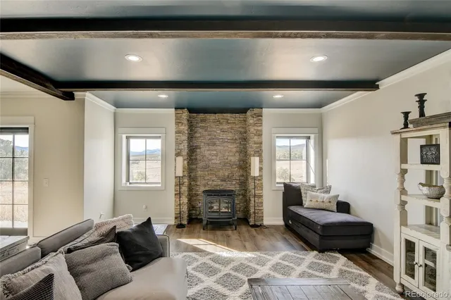 a living room with furniture a fireplace and a flat tv screen