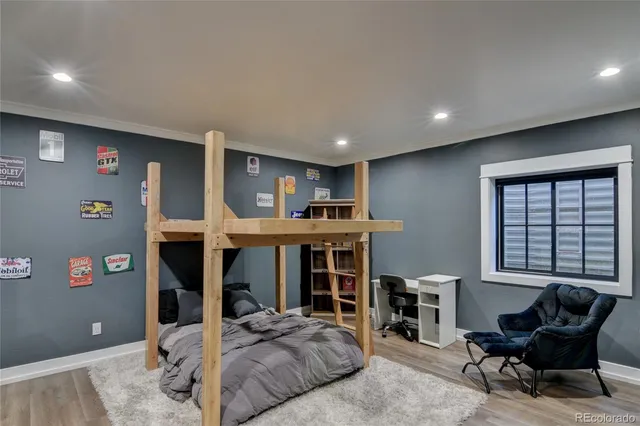 a bedroom with furniture and a large window