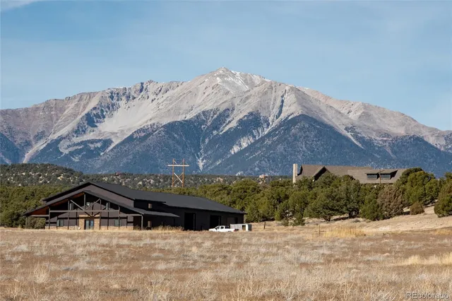 a view of a house with a snow in the background