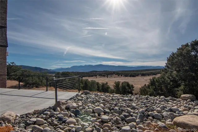 a view of a house with a yard and mountain