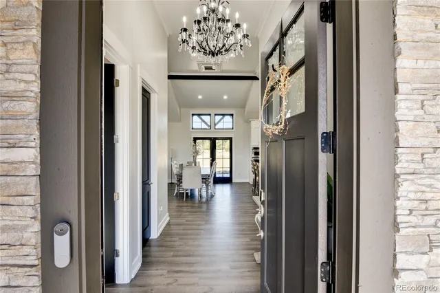 a view of a hallway with a livingroom and a dinning room with windows