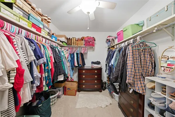 a view of walk in closet with clothes