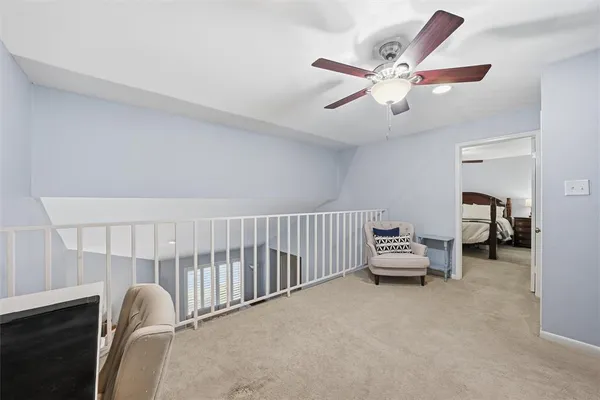 a bedroom with furniture and a ceiling fan