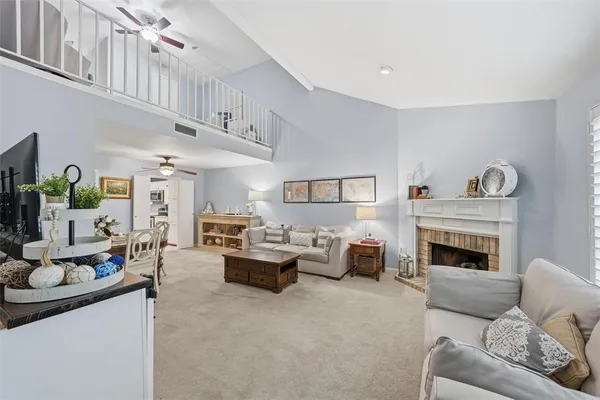 a living room with furniture fireplace and a window