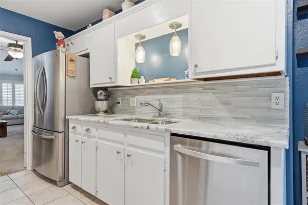 a kitchen with stainless steel appliances granite countertop a refrigerator and a stove