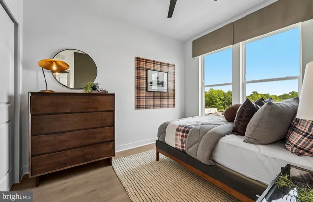 a bedroom with a large bed and a chandelier