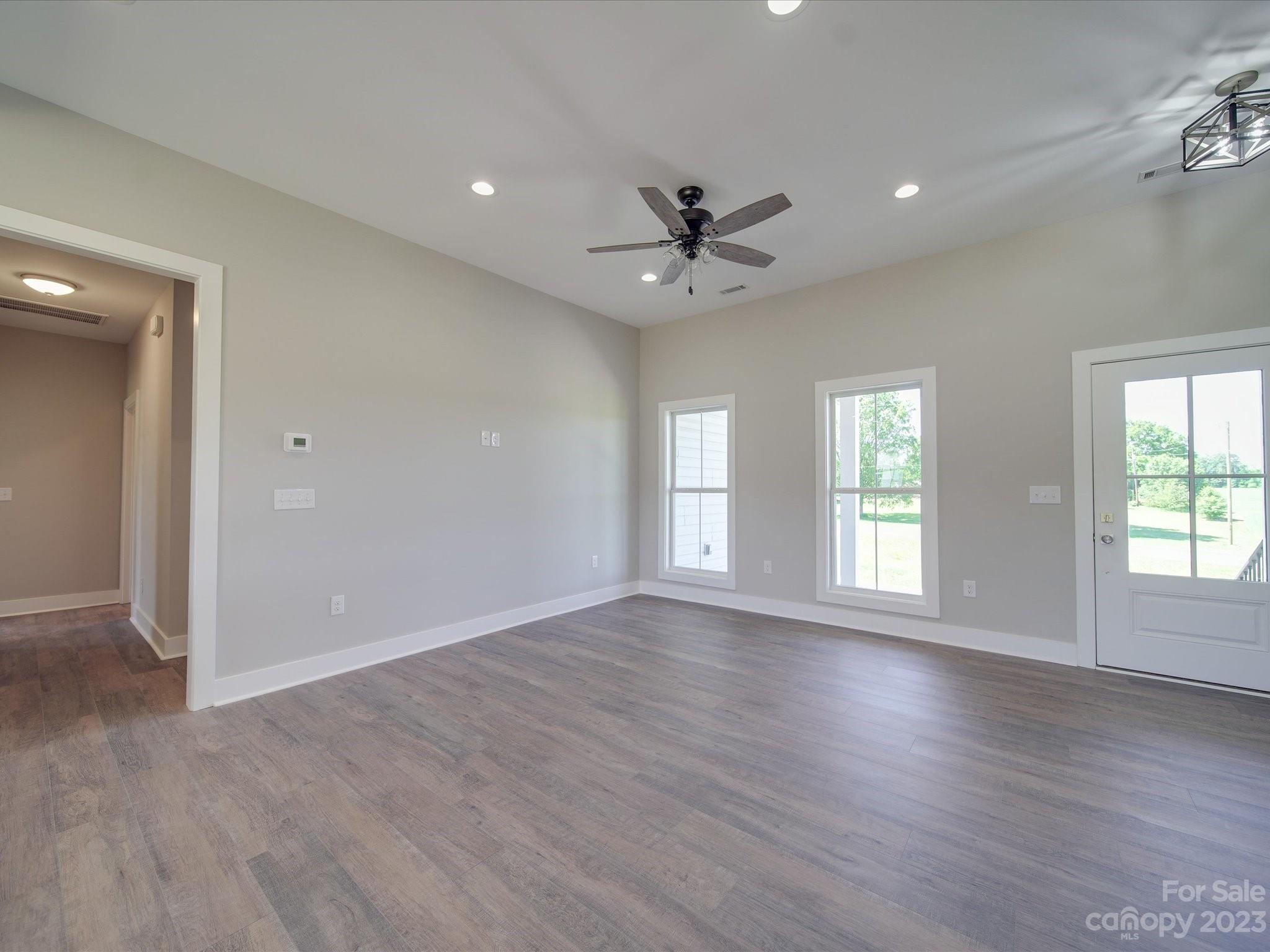 1321 Stack Road Monroe, NC 28112 - Photo 11 of 33 a view of an empty room with a window and wooden floor