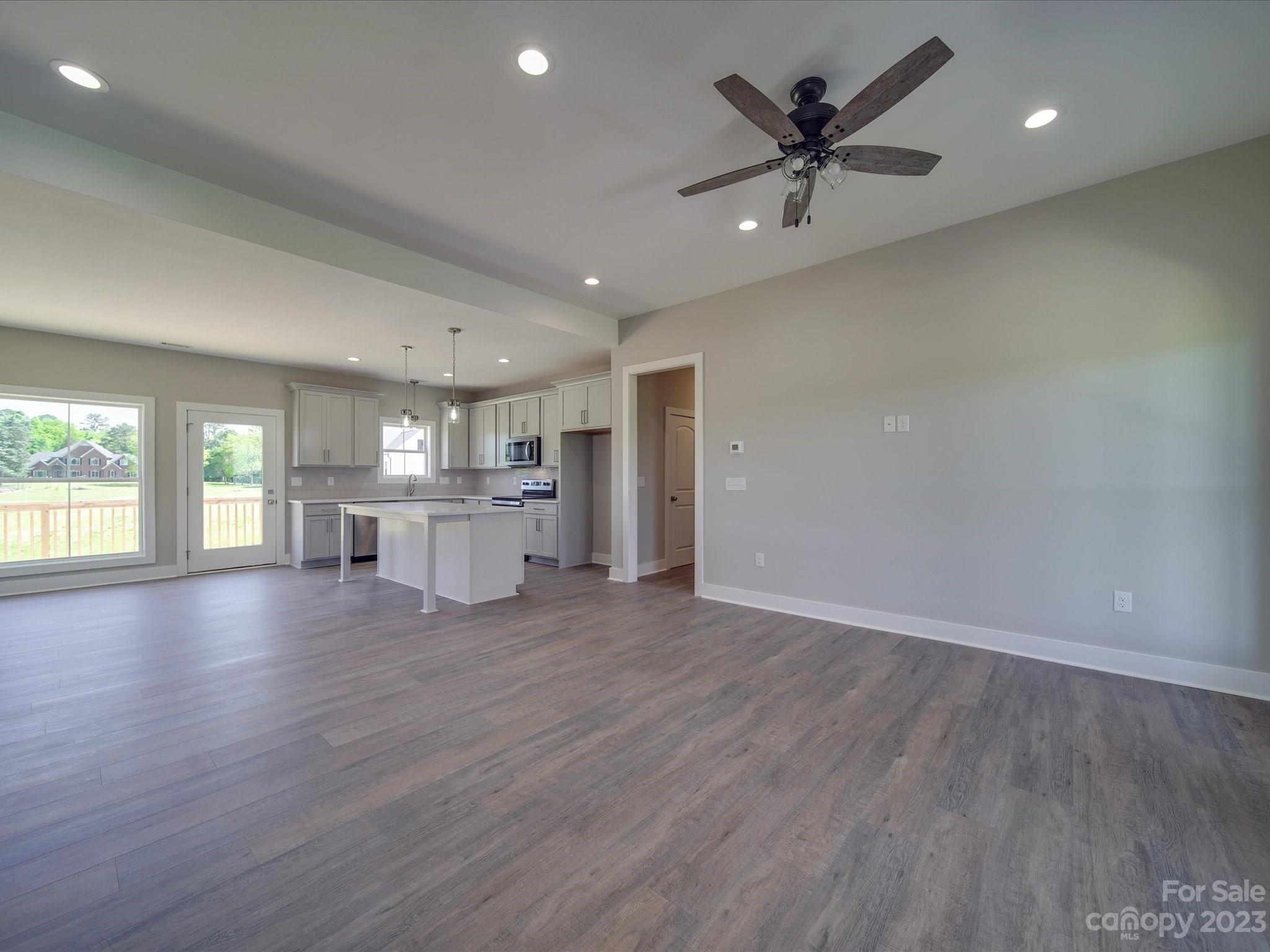 1321 Stack Road Monroe, NC 28112 - Photo 13 of 33 an empty room with wooden floor and windows