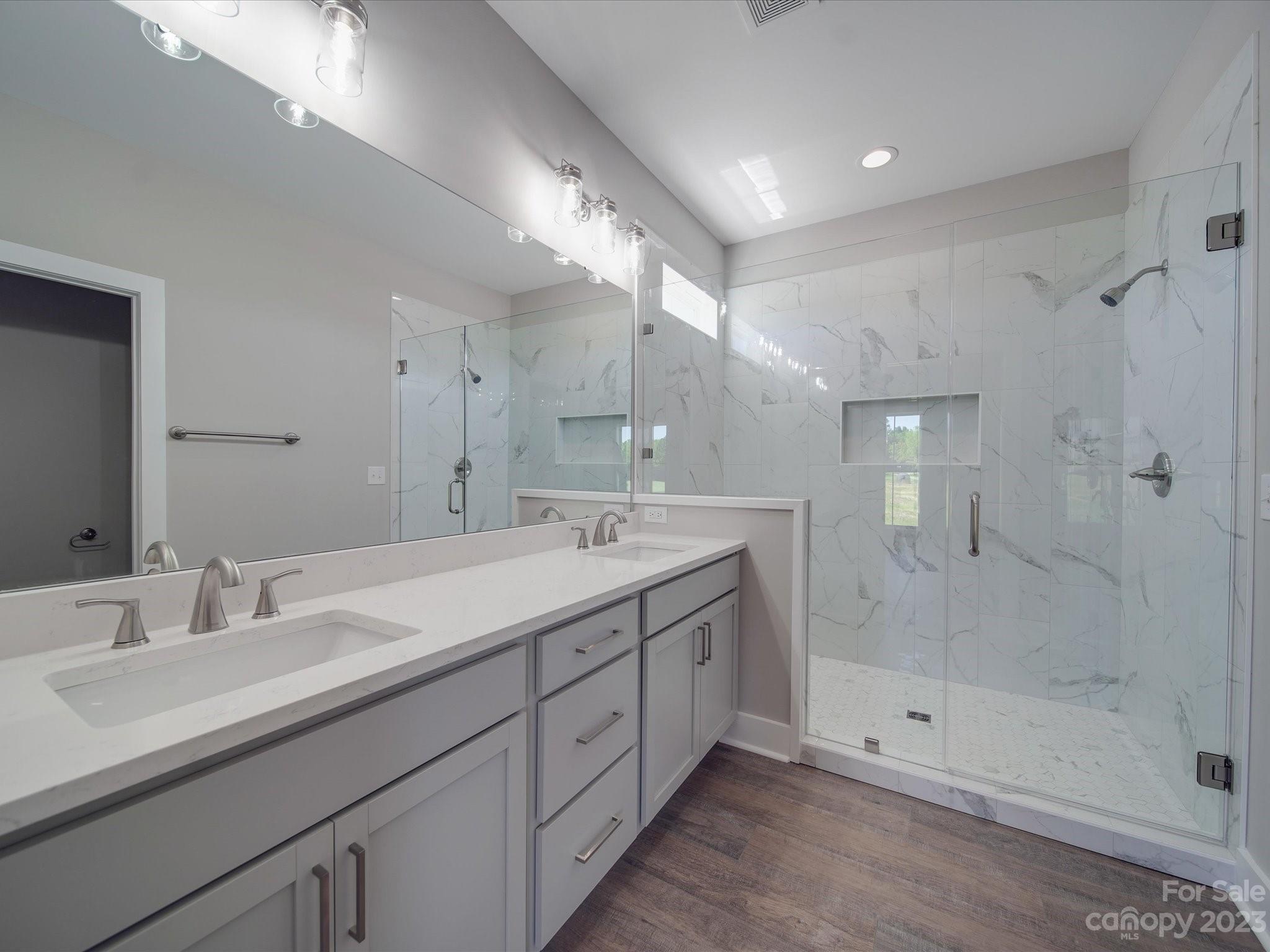 1321 Stack Road Monroe, NC 28112 - Photo 16 of 33 a spacious bathroom with double sink and shower