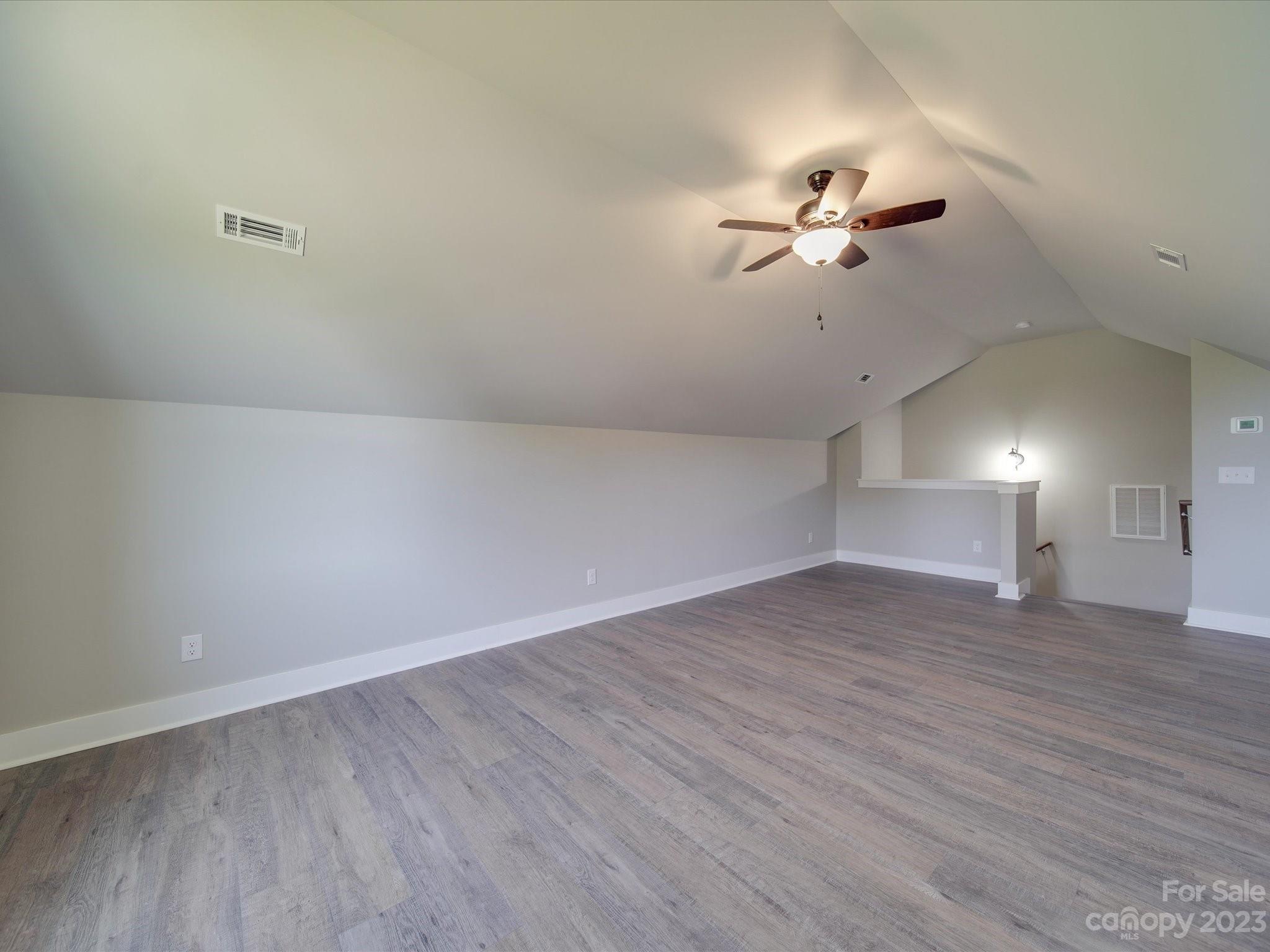 1321 Stack Road Monroe, NC 28112 - Photo 20 of 33 wooden floor in an empty room with a fan