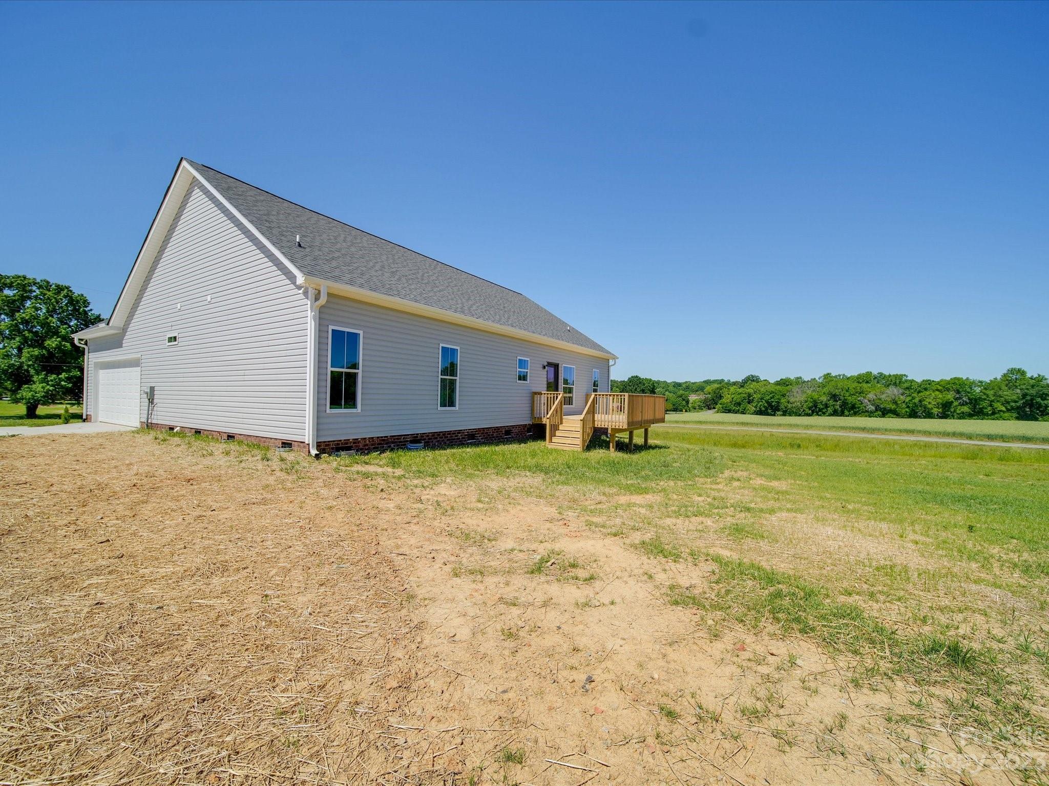1321 Stack Road Monroe, NC 28112 - Photo 29 of 33 a view of a house with backyard and lake view