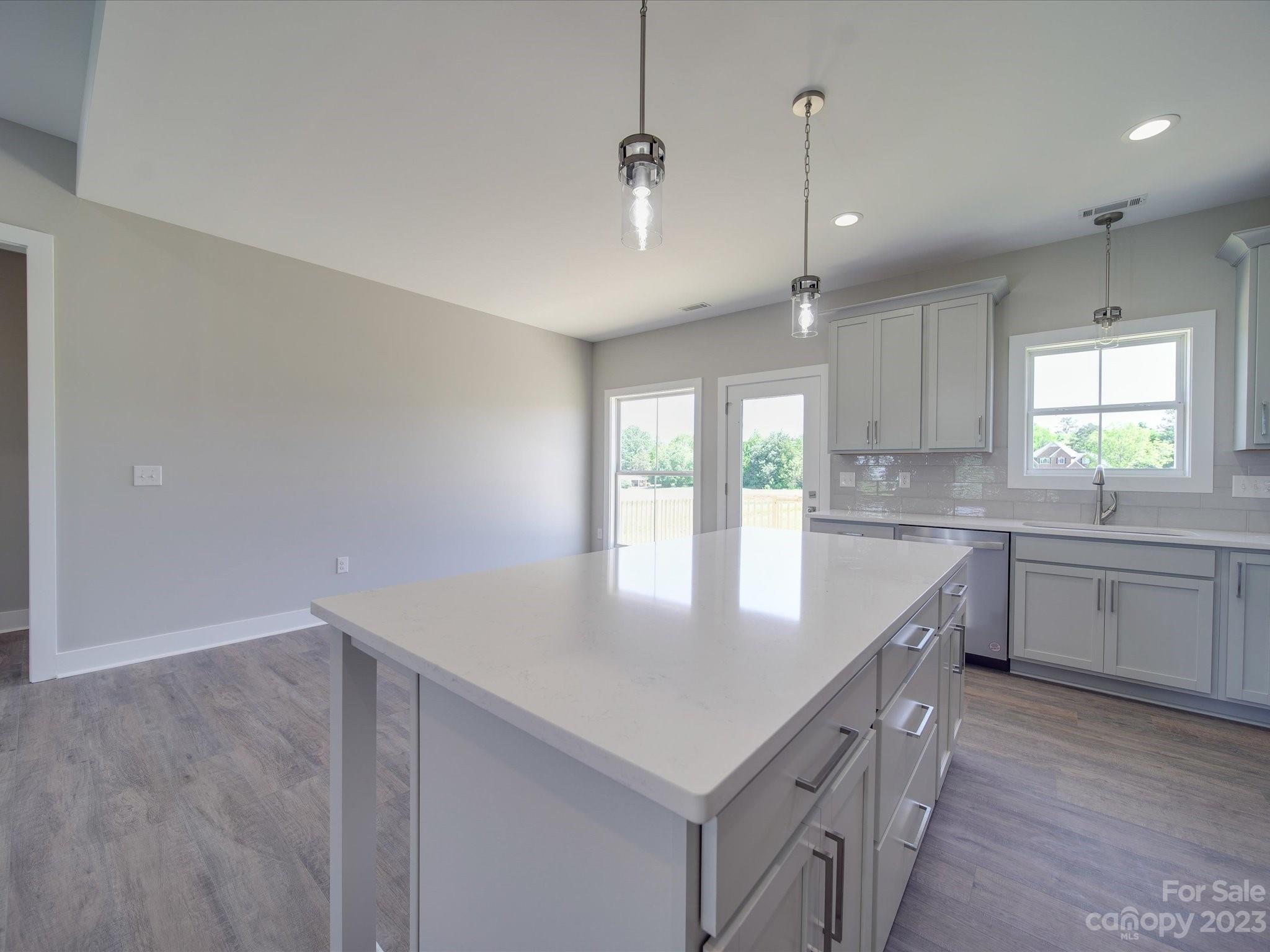 1321 Stack Road Monroe, NC 28112 - Photo 5 of 33 a kitchen with stainless steel appliances granite countertop a sink a window and white kitchen