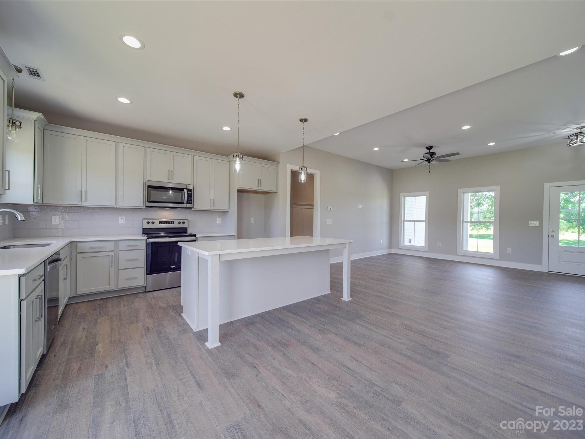 1321 Stack Road Monroe, NC 28112 - Photo 8 of 33 a kitchen with a white wooden floors stainless steel appliances and window