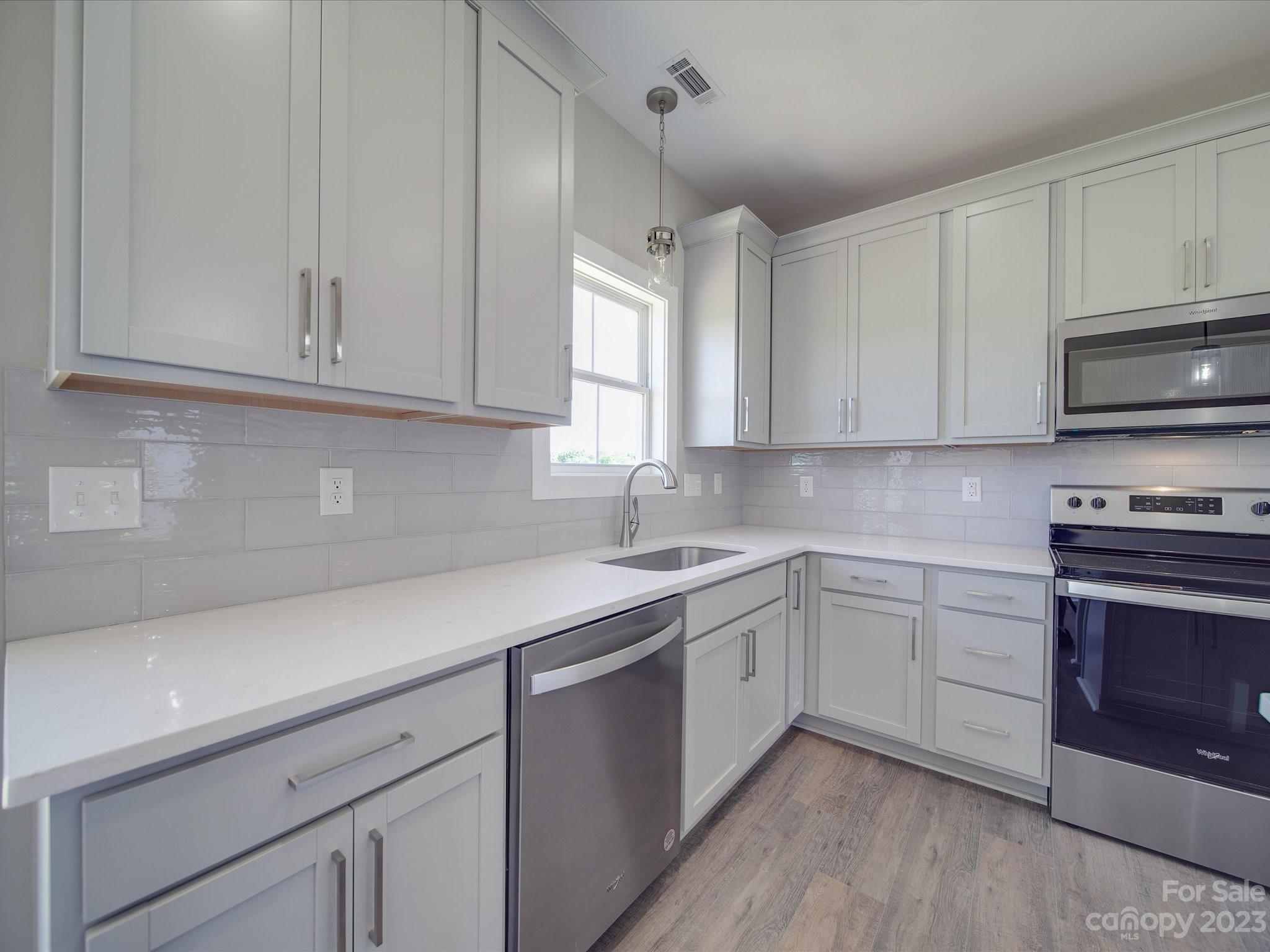 1321 Stack Road Monroe, NC 28112 - Photo 9 of 33 a kitchen with cabinets appliances a sink and a window