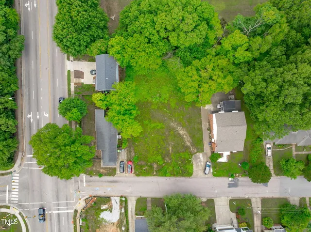 an aerial view of a house with a garden and plants