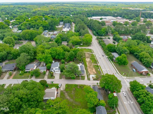 an aerial view of city lake and trees