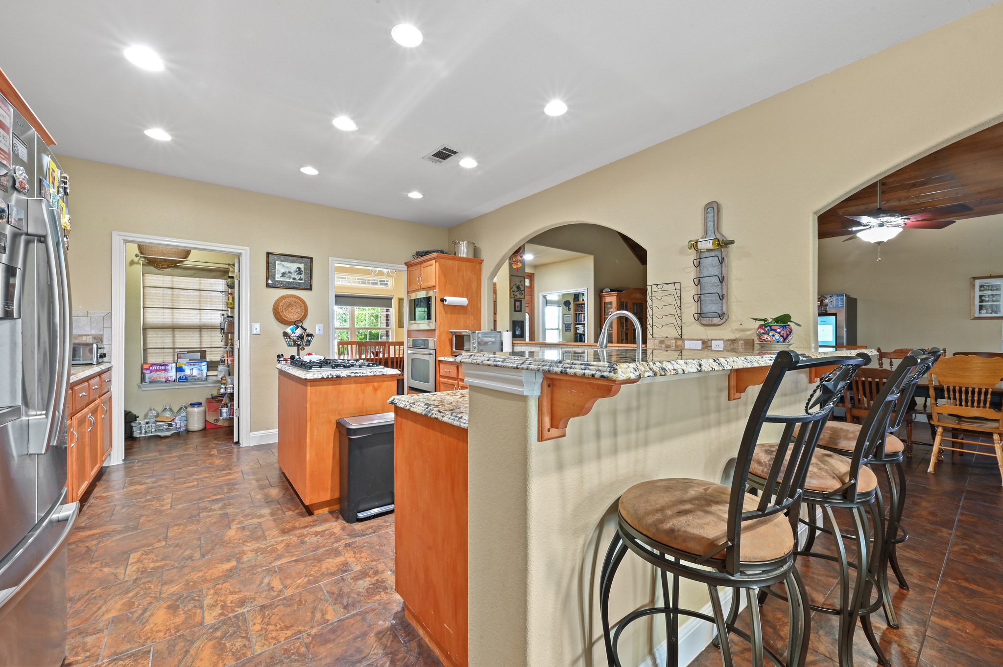 410 Simmons Family Farm Road Lockhart, TX 78644 - Photo 11 of 40 a dining hall with stainless steel appliances a dining table and chairs