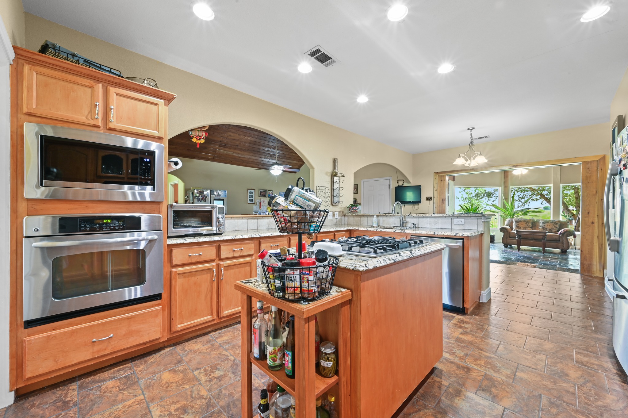 410 Simmons Family Farm Road Lockhart, TX 78644 - Photo 12 of 40 a kitchen with kitchen island a sink stove and microwave