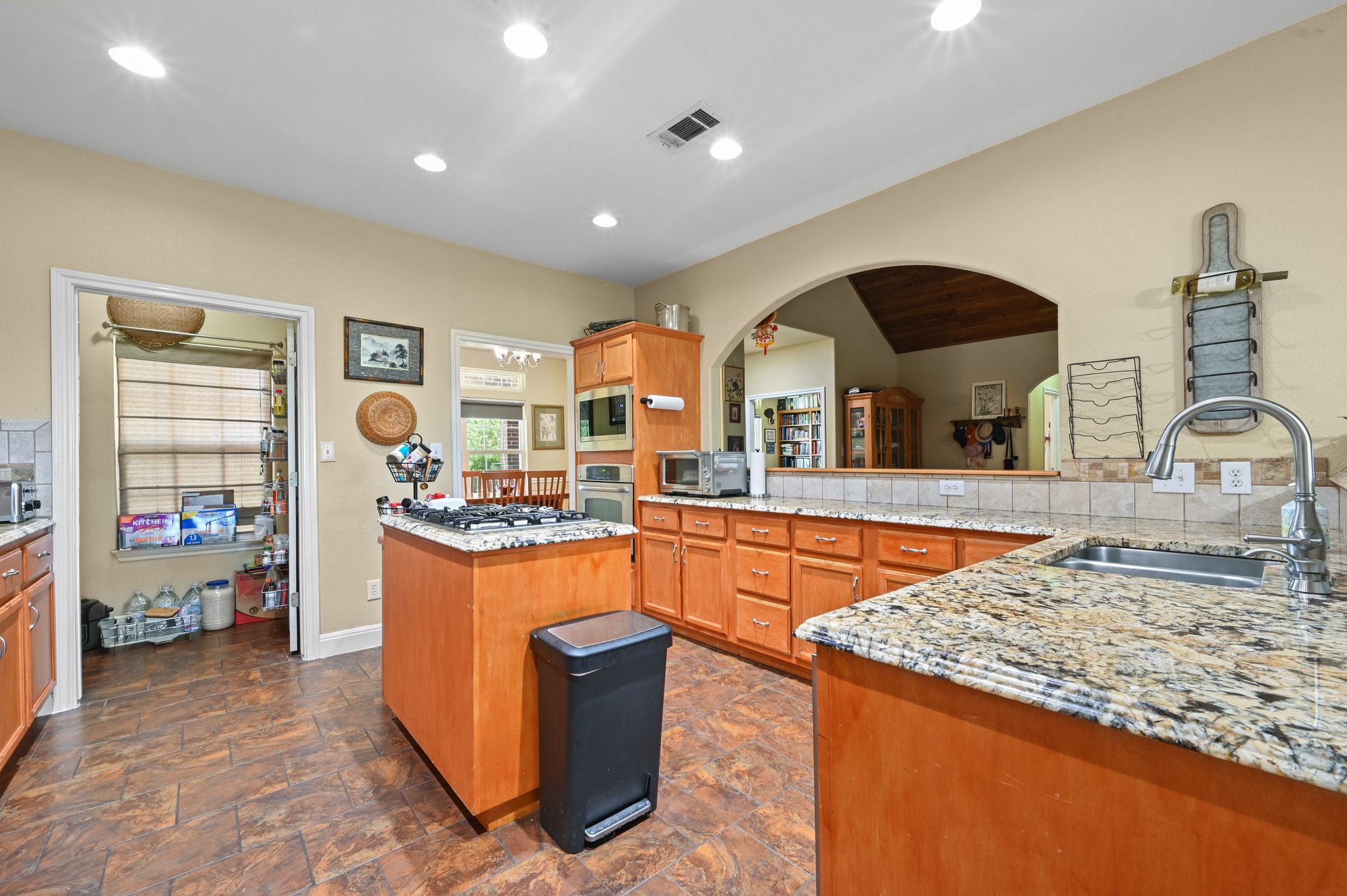 410 Simmons Family Farm Road Lockhart, TX 78644 - Photo 13 of 40 a kitchen with stainless steel appliances granite countertop sink stove and granite counter top
