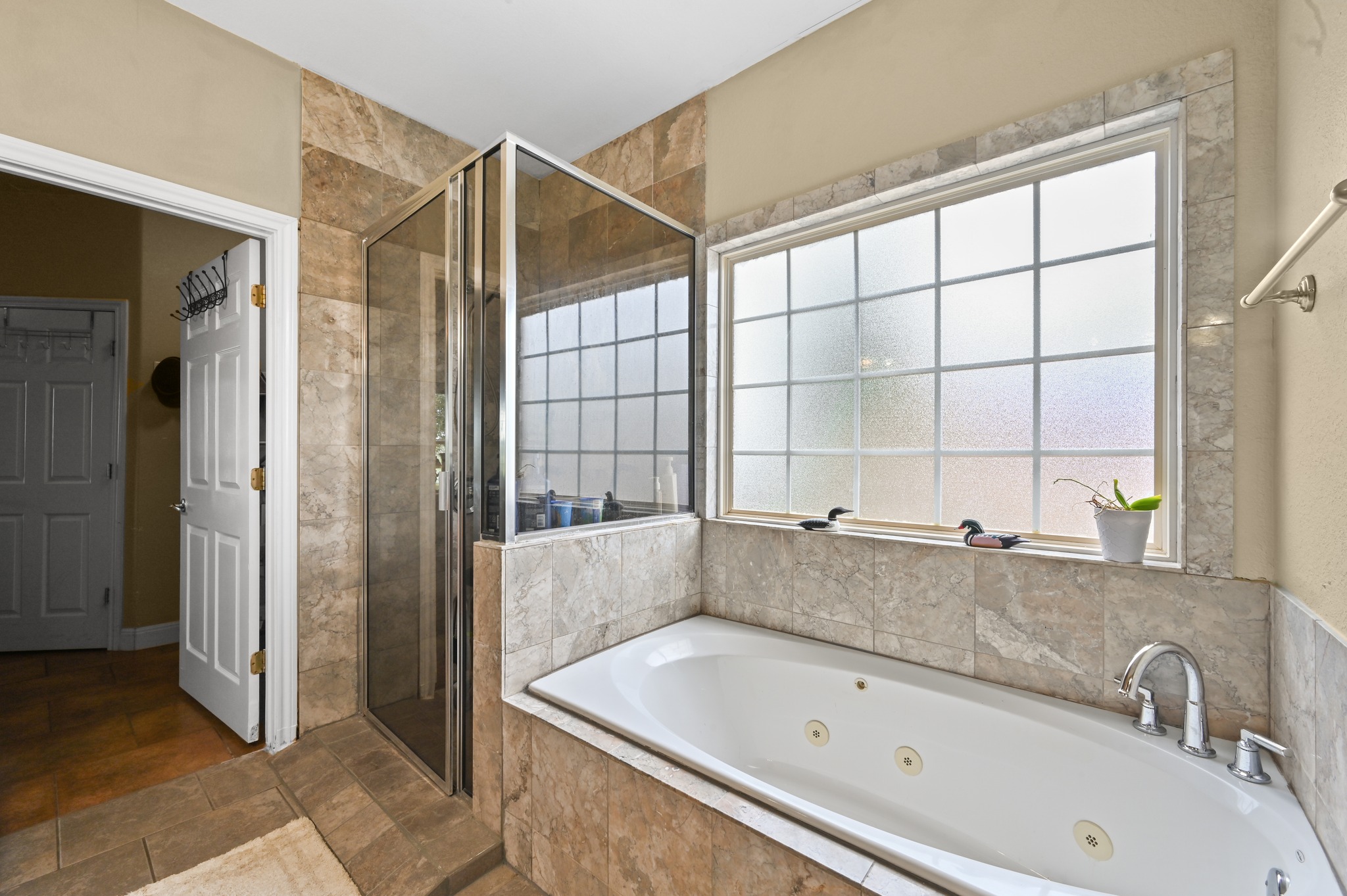 410 Simmons Family Farm Road Lockhart, TX 78644 - Photo 18 of 40 a bathroom with a bathtub and a shower
