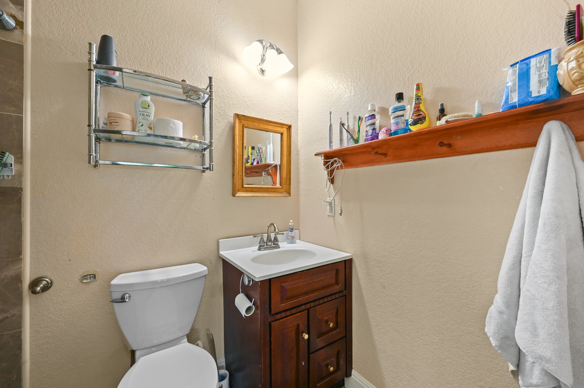 410 Simmons Family Farm Road Lockhart, TX 78644 - Photo 20 of 40 a bathroom with a sink a toilet and mirror