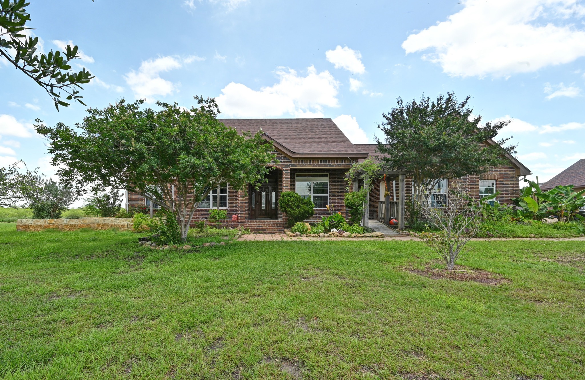 410 Simmons Family Farm Road Lockhart, TX 78644 - Photo 2 of 40 a view of a house with a yard and sitting area