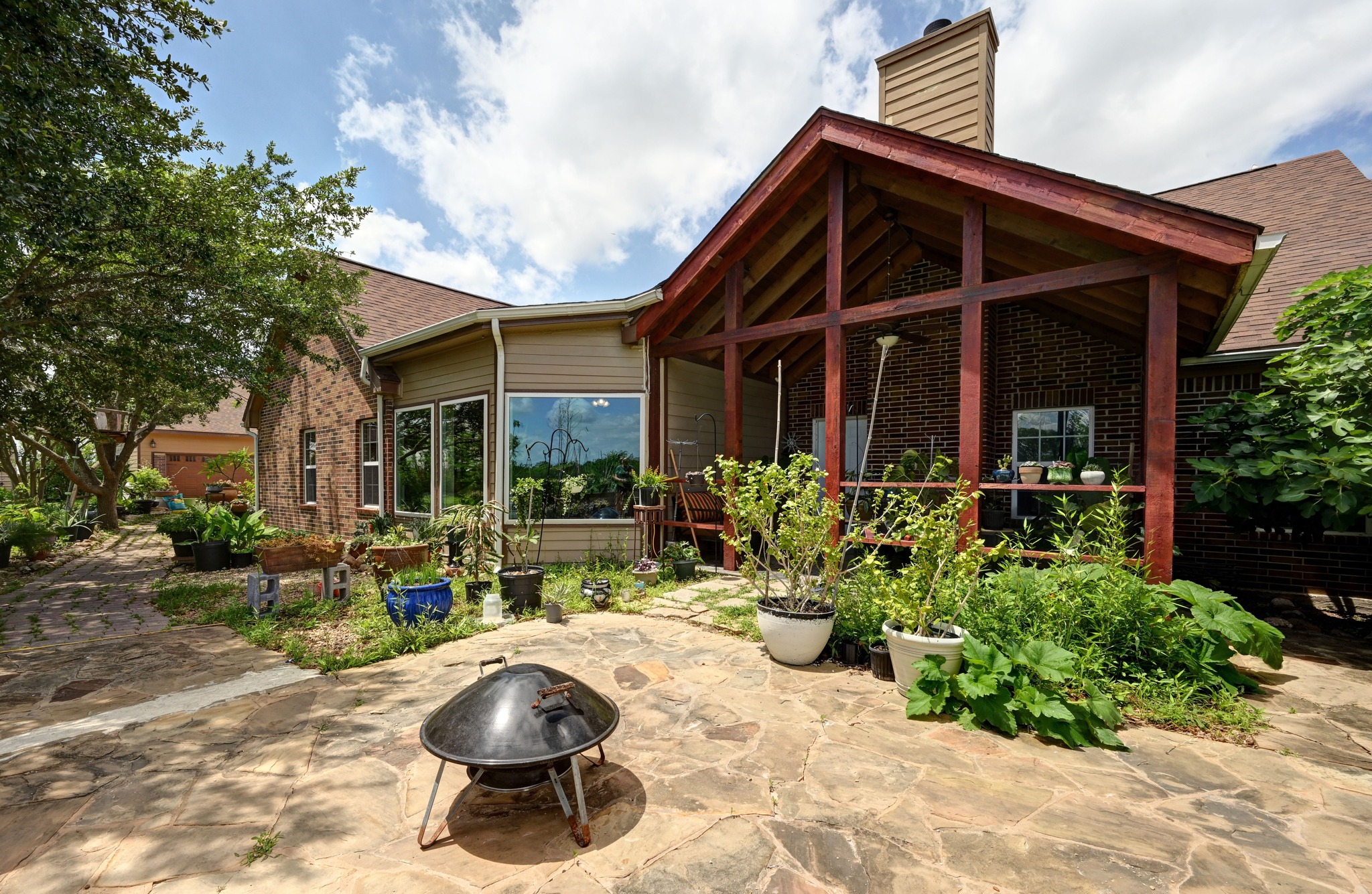 410 Simmons Family Farm Road Lockhart, TX 78644 - Photo 27 of 40 a view of a chair and tables in patio of the house