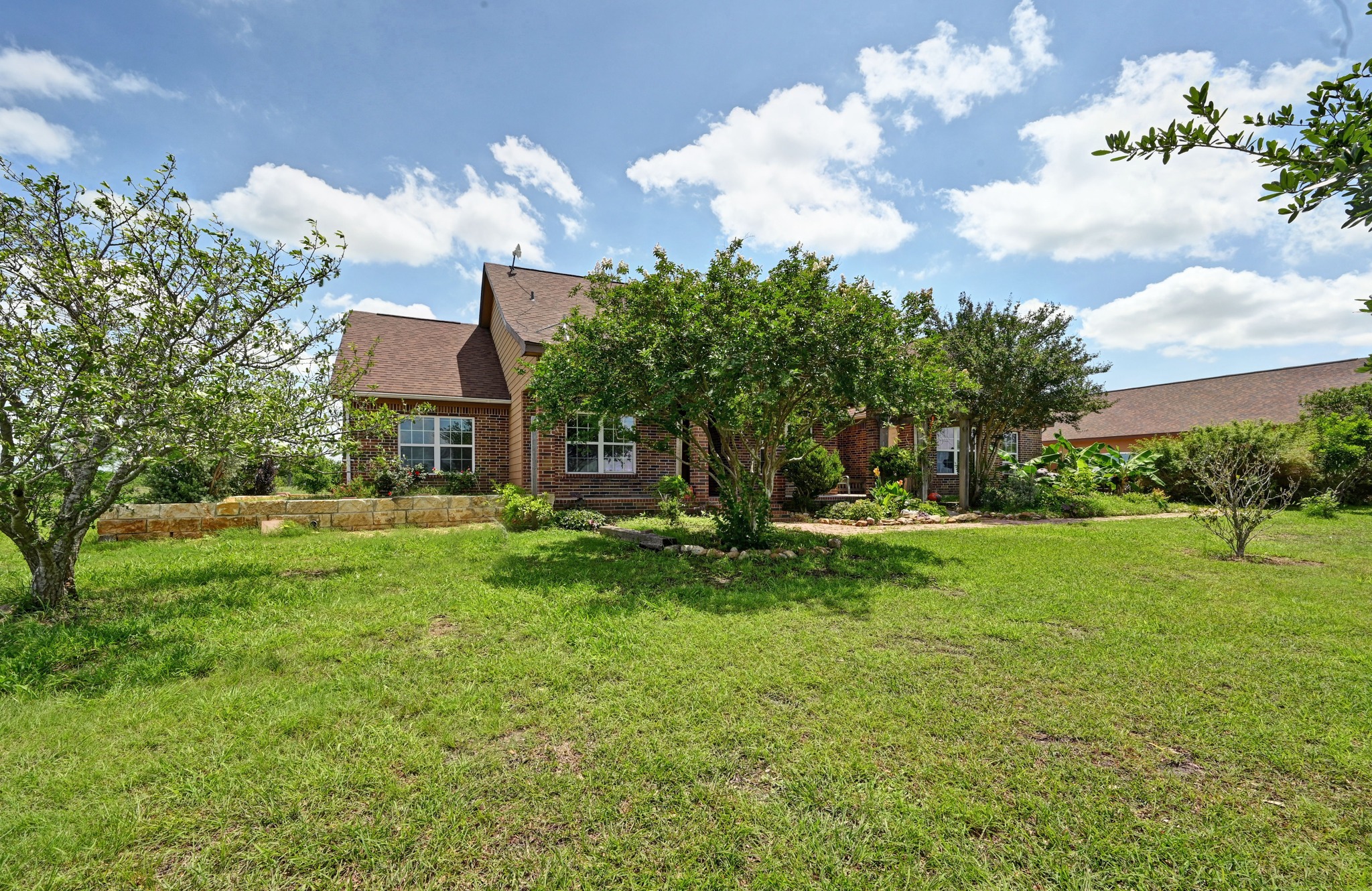 410 Simmons Family Farm Road Lockhart, TX 78644 - Photo 3 of 40 a view of a house with a big yard and a large tree